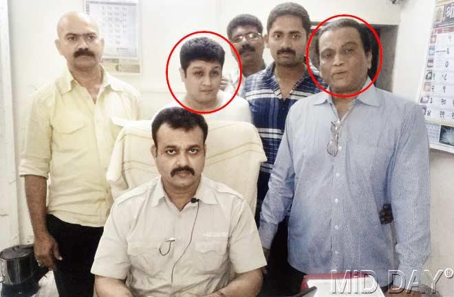 Chandrakant Mukherjee (circled, right) and his son Samarth (circled, left) at the Oshiwara police station