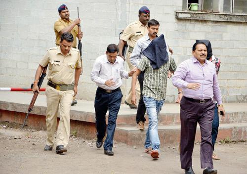 Startling claims: Manish Nagori and Vikas Khandelwal being taken to court on Tuesday afternoon by Pune Crime Branch officials