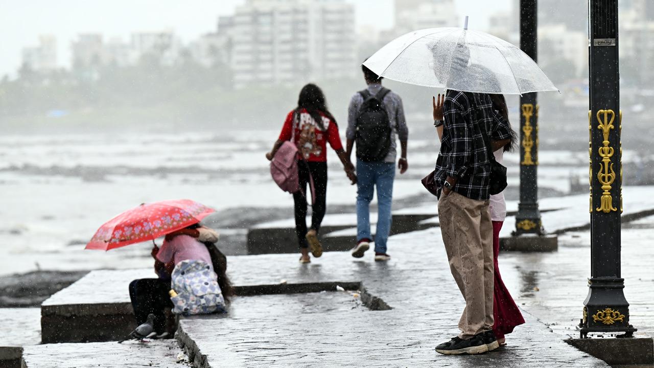 People enjoy rain showers in Bandra`s Bandstand on Tuesday. PIC/SATEJ SHINDE