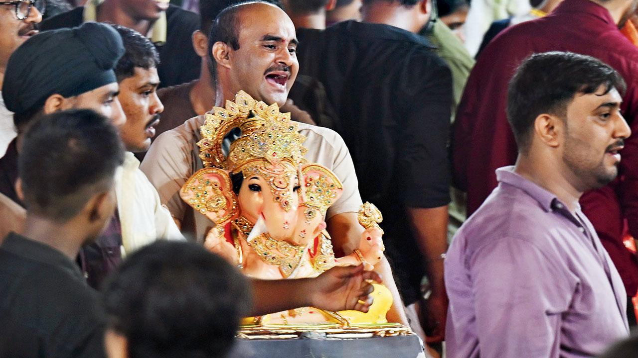 Devotees visit an artificial pond in the BMC garden at Thakur Village in Kandivli East, on Friday.  Pic/Satej Shinde
