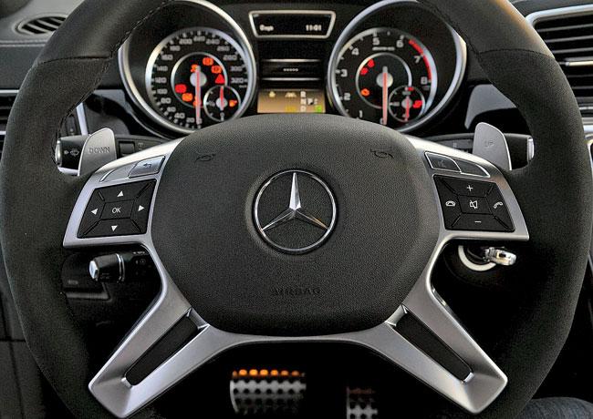 The four spoke flat-bottom AMG steering wheel has mounted pedals at the back for manual shifts 
