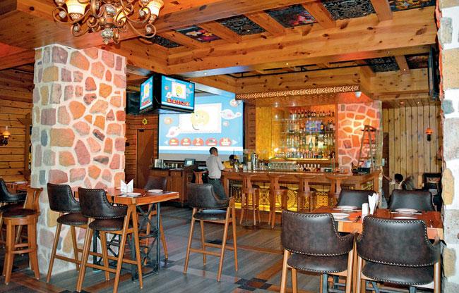 Stone pillars, carved wooden ceiling and Mexican mafia paintings — it all comes together at Tap Sports Bar. Pics/Prashant Waydande