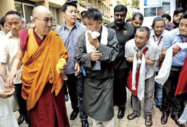 Followers with the Tibetan spiritual leader, The Dalai Lama, during his visit to Mumbai. PIC/AFP