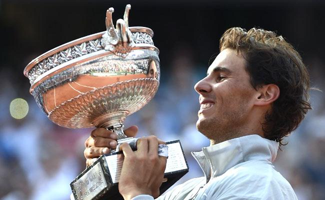 Rafael Nadal holds the Musketeers trophy after winning the French Open