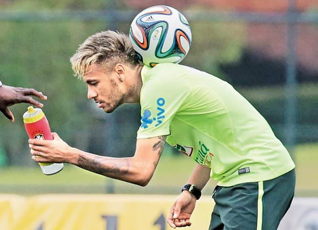 Brazilian striker Neymar balances the ball during a training session at the Granja Comary training complex in Teresopolis. Pic/AFP