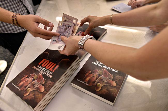People buy books by Zaihan Mohamed Yusof, an investigative reporter with Singapore