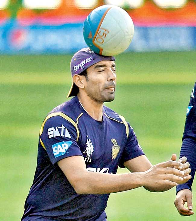 Robin Uthappa heads the ball during a practice session in Bangalore on Saturday