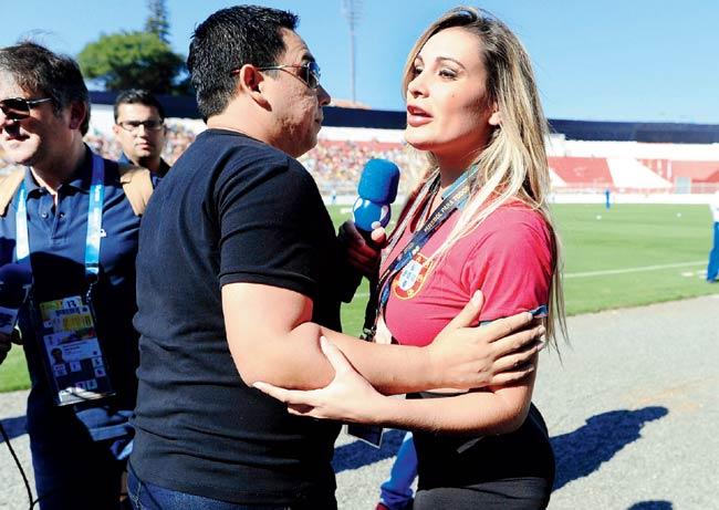 Andressa Urach is escorted by a security guard out of the grounds during a Portugal training on Wednesday. Pic/AFP
