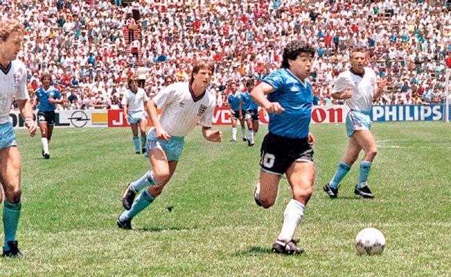 Diego Maradona (in blue) runs past Terry Butcher (left) and Terry Fenwick (second from left) on his way to scoring a goal during the 1986 World Cup quarter-final tie against England in Mexico