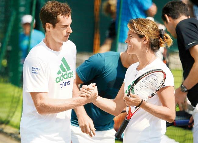 Defending champion Andy Murray with coach Amelie Mauresmo during a practice session at Wimbledon yesterday. Pic/Getty Images