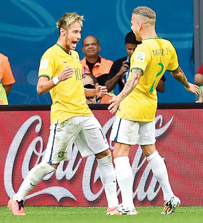 Brazil’s Neymar and Dani Alves celebrate after scoring a goal. 