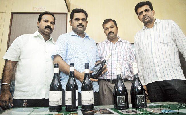 The excise flying squad with some of the seized liquor in Sakinaka. Pic/Pradeep Dhivar