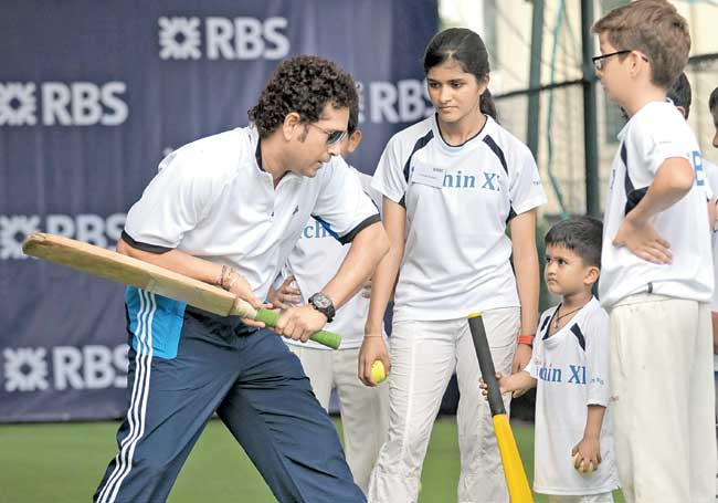 Sachin Tendulkar interacts with kids during a promotional event in Singapore yesterday. Pic/AFP