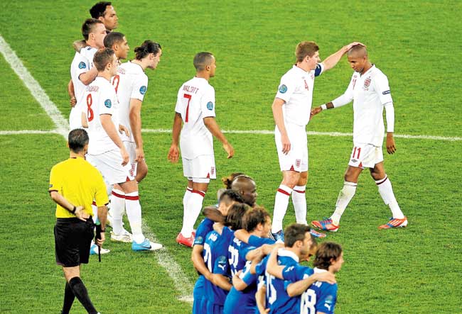 Ashley Young (right) is consoled by Gerrard after his penalty miss in the 2012 Euro quarter-final against Italy in Kiev in 2012. Pic/Getty Images