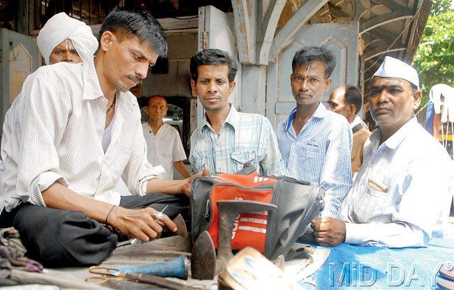 Stitch in time: A volunteer from a Ganesh mandal mends a warkari’s bag  