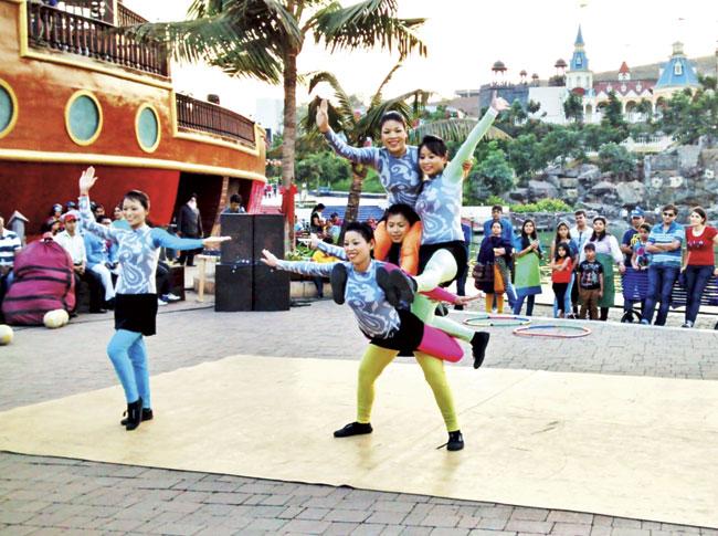 Babita KS with the acrobatic group performing at the theme park