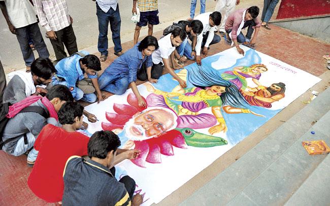 Allahabad University Fine Art students create a banner urging PM Narendra Modi to clean the River Ganga. Pic/AFP
