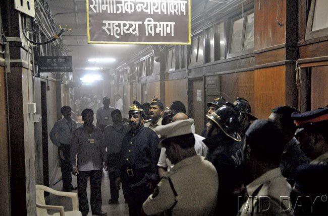Officials inspect the corridor adjoining the social justice department and close to the chamber of Minister of State for Tribal Affairs Rajendra Gavit, where the short circuit occurred