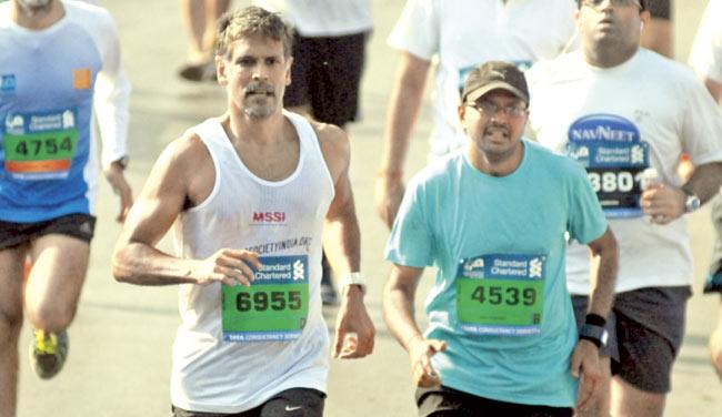Milind Soman (left) running in the Mumbai Marathon this year. Soman raises awareness about multiple sclerosis (MS)
