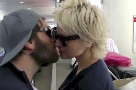 Pamela Anderson shares an intimate kiss with boyfriend at airport