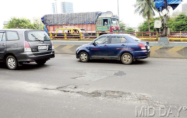Potholes have appeared on the flyover in the first few spells of the rains. Pic/Kaushik Thanekar