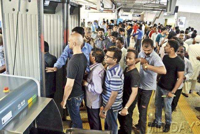 Mumbaikars wait in line to ride the Metro
