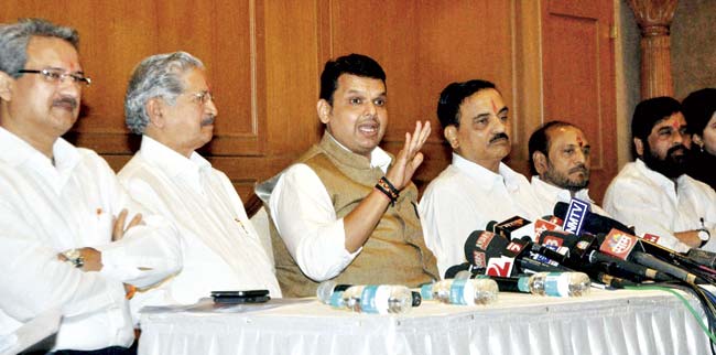 CM Devendra Fadnavis addresses a press conference with Shiv Sena leaders (left to right) Anil Desai, Subhash Desai, Diwakar Raote, Ramdas Kadam and Eknath Shinde on Thursday. Pic/PTI