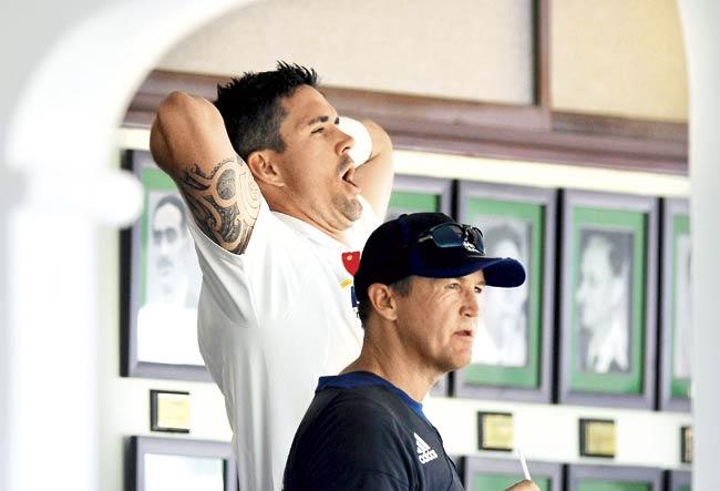 Kevin Pietersen and Team Director, Andy Flower (front) outside the dressing room during the second day of the first practice match between England and India A at the CCI ground on October 31, 2012, in Mumbai. Pic/Getty Images
