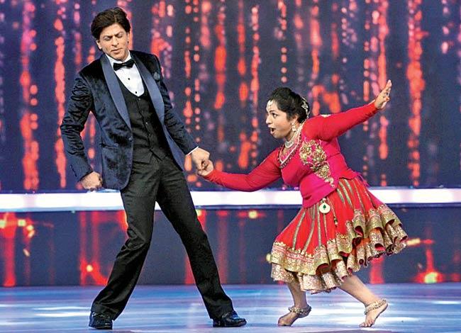 Shah Rukh Khan (left) with contestant Nora John