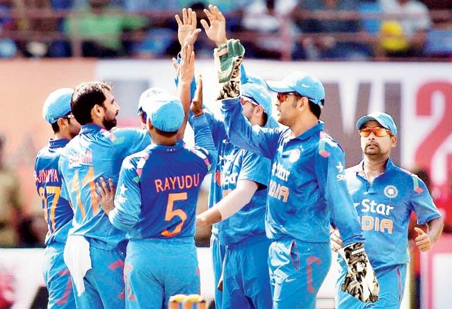 Indian players celebrate the wicket of West Indies captain Dwayne Bravo in the first ODI in Kochi on Wednesday. Pic/PTI
