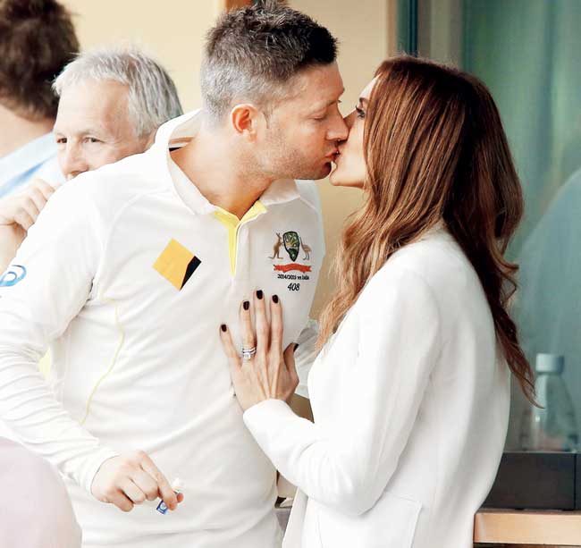Australia captain Michael Clarke kisses wife Kyly during a rain delay on Day Two of the first Test against India at the Adelaide Oval yesterday. Pic/Getty Images