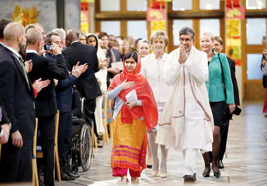 Nobel Peace Prize laureates Kailash Satyarthi and Malala Yousafzai arrive for the Nobel Peace Prize awards ceremony at the City Hall in Oslo, Norway.