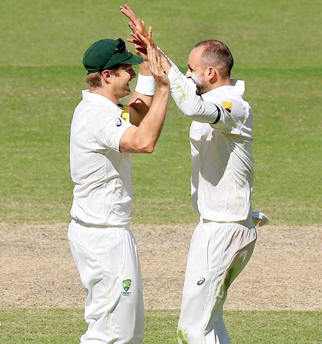 Nathan Lyon (right) celebrates a wicket with Shane Watson yesterday. Pic/Getty Images