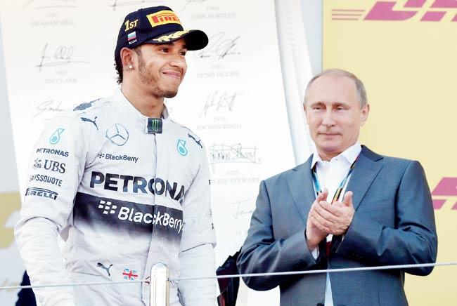 Russian President Vladimir Putin applauds as Mercedes