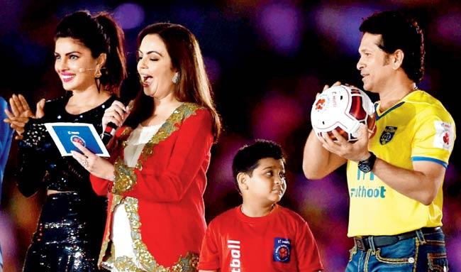 ISL founding chairperson Nita Ambani (centre) declares the Indian Super League open as Sachin Tendulkar (right) and Priyanka Chopra look on at the Salt Lake Stadium. Pics/PTI
