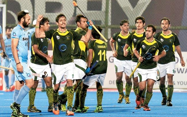 India skipper Sardar Singh (left) is dejected as Pakistan players celebrate a goal at the Kalinga Stadium in Bhubaneswar on Saturday. Pic/AFP