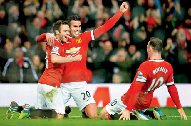 Top trio: Man United-s Robin van Persie celebrates with teammates Juan Mata left and Wayne Rooney right after scoring the team-s third goal against Liverpool in an EPL match at Old Trafford in Manchester yesterday. Mata and Rooney got the other two goals for United. Pics/AFP