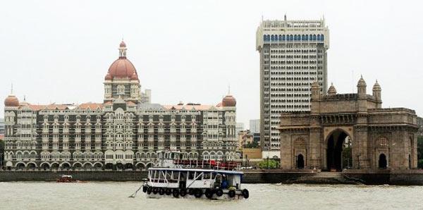 The Gateway of India (R) and Taj Mahal Palce & Tower. Pic/AFP