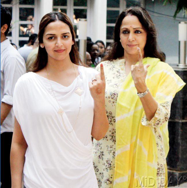 Hema Malini (right) with daughter Esha after exercising their franchise