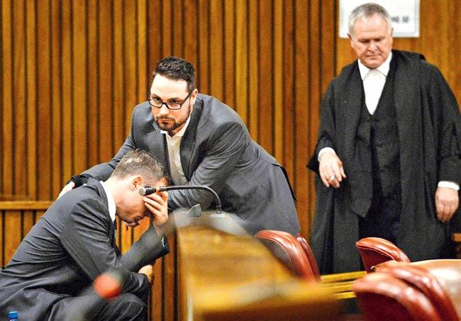 A weeping Oscar Pistorius is comforted by his brother Carl Pistorius during the sentencing hearing at the Pretoria High Court yesterday. Pic/AFP