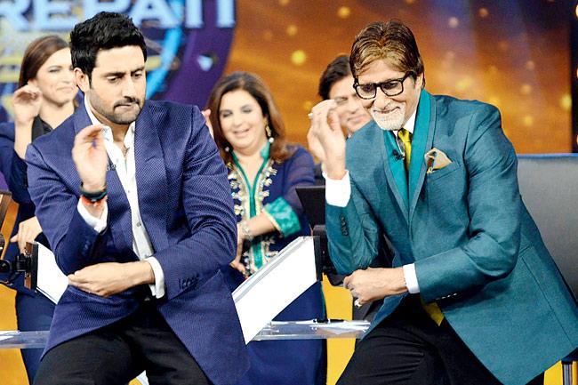 Abhishek Bachchan shakes a leg with (right) Amitabh Bachchan on the sets of Kaun Banega Crorepati 