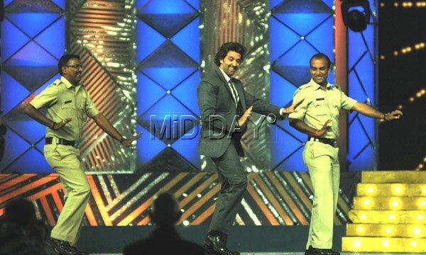 Law and behold: Hrithik Roshan shows his signature move at a Mumbai police show in January as two cops match steps with him