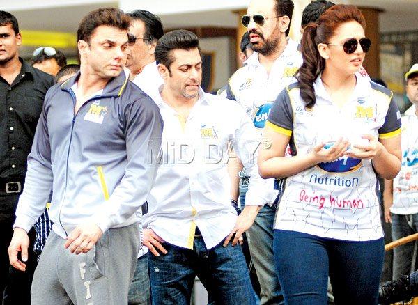 Oh, bummer: What caught Sohail Khan (left) and Salman Khan’s attention at a celebrity cricket match in January? Surely Huma Qureshi has no idea