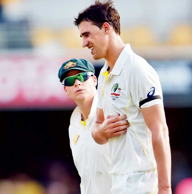 Steve Smith looks concerned about Mitchell Starc