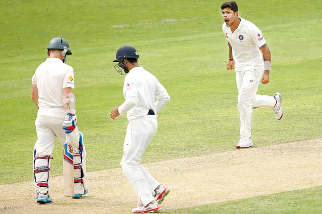 Umesh Yadav celebrates the wicket of Chris Rogers at the Gabba yesterday. Pic/Getty Images