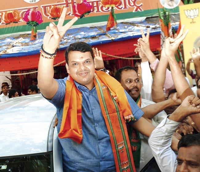 Devendra Fadnavis, who is tipped to be the next CM of Maharashtra, celebrates with supporters yesterday