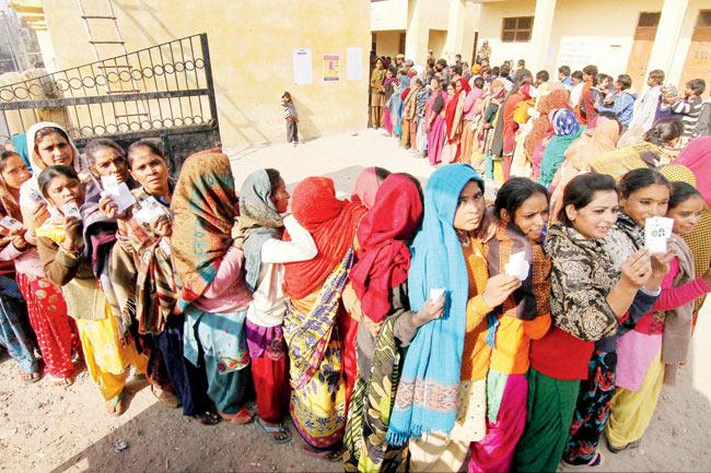 Voters wait in queues to cast their votes at a polling during the fifth phase of the J&K Assembly elections in Jammu on Saturday. Pic/PTI