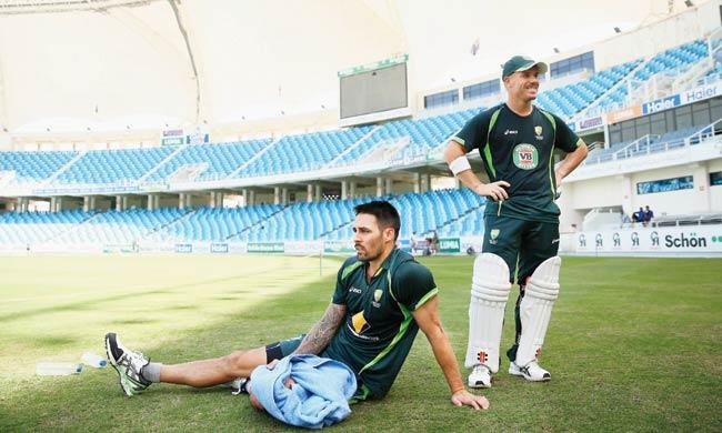 Mitchell Johnson (left) and David Warner take a break during a practice session in Dubai yesterday. Pics/Getty Images