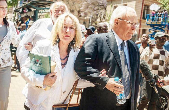 It-s over: Late Reeva Steenkamp-s father Barry Steenkamp back right and mother June Steenkamp left with their lawyer Dup de Bruyn right leave Pretoria High Court after the trial of Oscar Pistorius who was been sentenced to five years jail yesterday