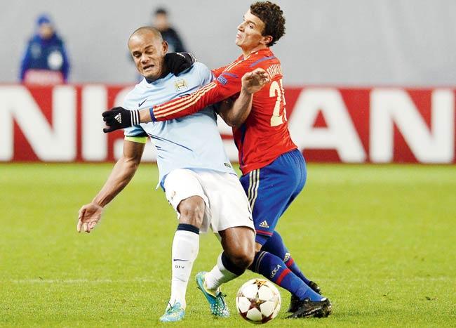 Man City skipper Vincent Kompany (in blue) is tackled by CSKA Moscow